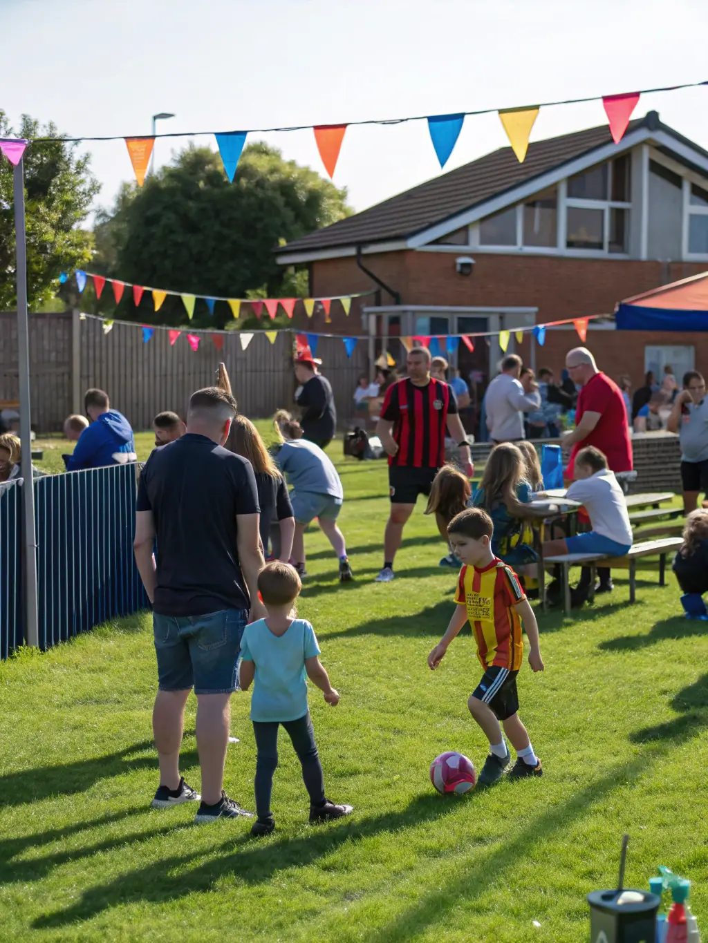 Image of a community outreach event organized by PLANCOET ARGUENON FOOTBALL CLUB, featuring children and families participating in football-related activities and games.